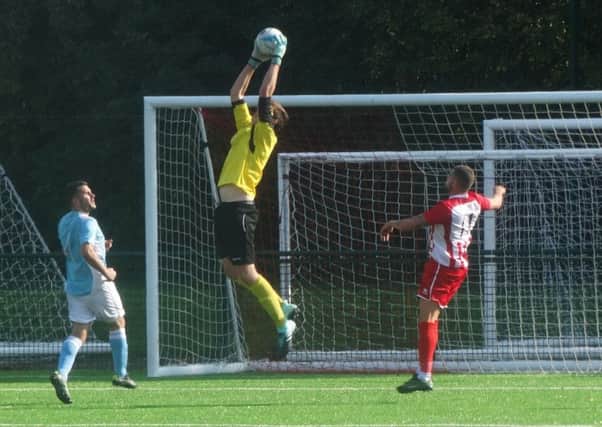 Bexhill United goalkeeper Dan Rose catches a ball into the area during last weekend's defeat away to Steyning Town. Picture courtesy Mark Killy