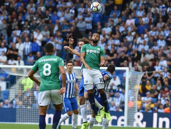 Matt Phillips jumps for a header against Brighton on Saturday. Picture by Phil Westlake (PW Sporting Photography)