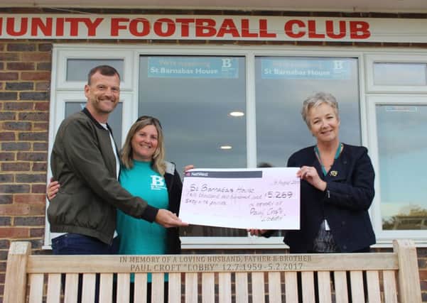 Millie (left) presenting the cheque to St Barnabas House hospice. Picture: Wendy Bardsley