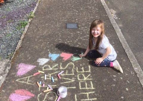 Naomi Squires hosted a street party to raise money for Macmillan. Ruby, Naomi's niece, chalk drawing