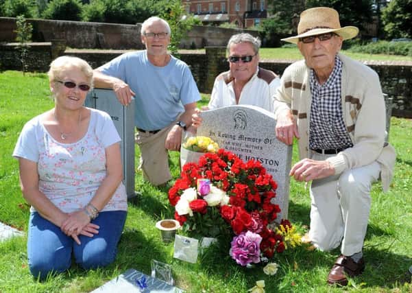 Linda Johnson, Peter Logan, and (right ) John Logan with the homeless man who has been caring for flowers in Storringtons churchyard. Picture: Steve Robards