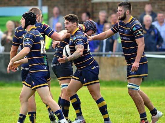 Sam Hampson celebrates with team-mates after going over for Raiders on Saturday. Picture by Stephen Goodger
