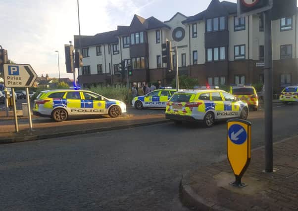 Police outside the flats in Horsham on Tuesday (September 19)
