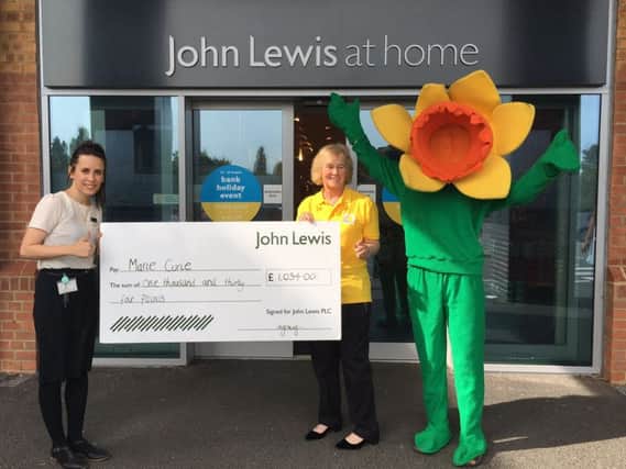 Abbie Jones, branch operations assistant of John Lewis Chichester, Marie Curie volunteer Jan Nash, and Kate Megson, community fundraiser for West Sussex, dressed as the Marie Curie mascot 'Daffy'