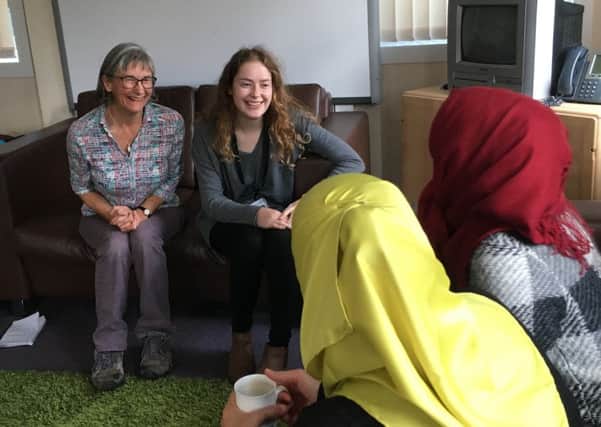 Sanctuary in Chichester members Mary Downy  and Tazmin Mirza chatting to a mother and daughter from Syria at the groups drop-in session