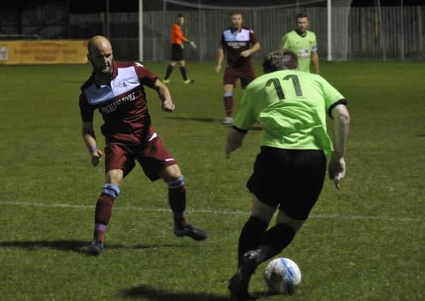 Little Common player-manager Russell Eldridge closes down a Ringmer opponent during the abandoned first meeting between the clubs. Picture by Simon Newstead