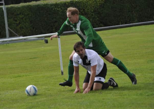 Chris Rea takes a tumble during Bexhill United's 1-0 defeat at home to Mile Oak last weekend. Pictures by Simon Newstead