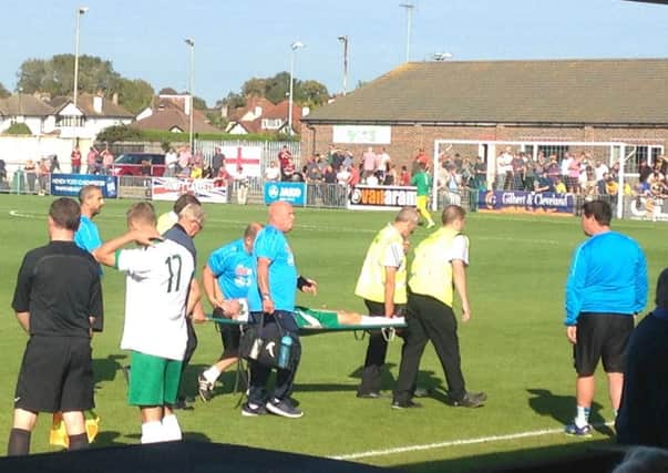 James Crane is taken away on a stretcher after dislocating his shoulder