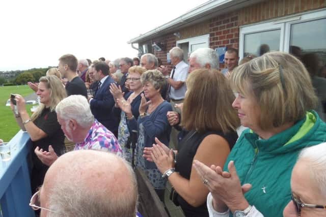 Spectators perform a minute's applause for Len Bolton. Picture courtesy Peter Knight