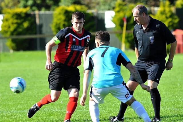 Wick skipper Andy Weir plays a pass in the match with AFC Varndeanians. Picture by Stephen Goodger