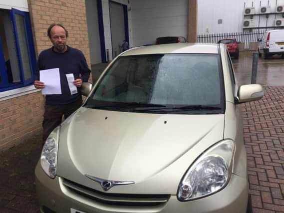 Mike Guppy with his car, parking ticket and receipt from Pets at Home