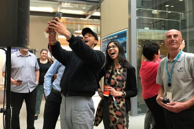 Jordan Stephens from Rizzle Kicks poses for selfies with Legal and General employee Gurganpreet Kang after a talk in their Hove offices