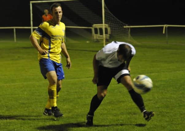 Bexhill United full-back Chris Rea nods the ball out of play against Langney Wanderers on Wednesday night. Pictures by Simon Newstead