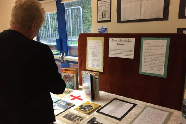 Visitors look at a display about the bombing at Petworth CofE Primary School