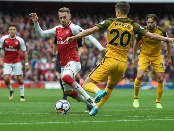 Solly March challenges Arsenal midfielder Aaron Ramsey. Picture by Phil Westlake (PW Sporting Photography)