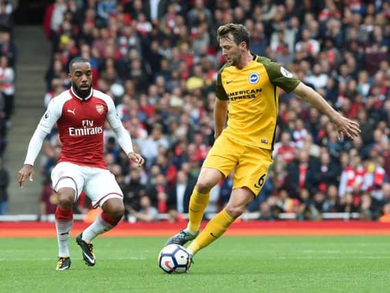 Dale Stephens turns away from Alexandre Lacazette. Picture by Phil Westlake (PW Sporting Photography)