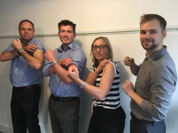 Dr David Supple,Dr Andy Hodson and Dr Katie Stead, receiving flu jab from pharmacist Matthew Seymour from Lane and Stedman, Hove