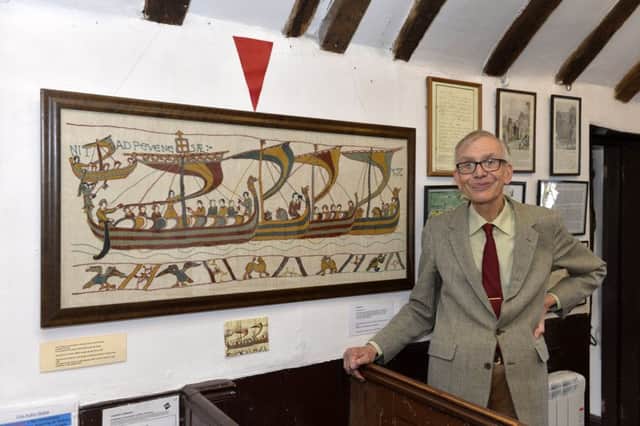 Curator Peter Harrison with the hand-embroidered Bayeux Tapestry replica scene