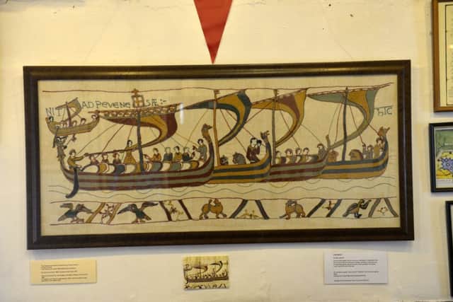 The replica shows the Pevensey landing scene from the Bayeux Tapestry
