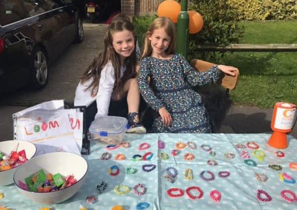 Edie and Darcy selling their loom bands in Horsham