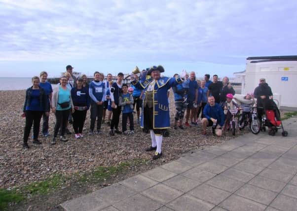 Worthing town crier Bob Smytherman with runners at Miles for Meso