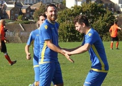 Weller is congratulated by a couple of his Rye team-mates.