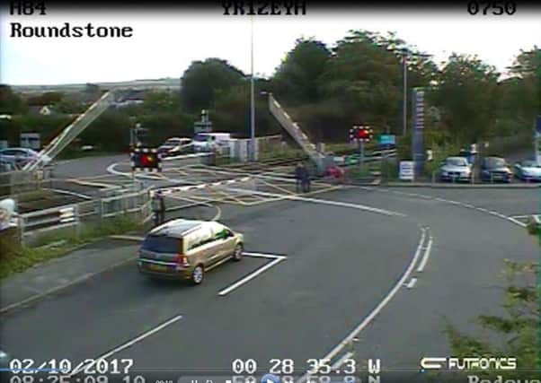 CCTV footage of the cyclist, seen in pink, just before getting caught on the tracks at the Roundstone level crossing in East Preston. Picture: Network Rail