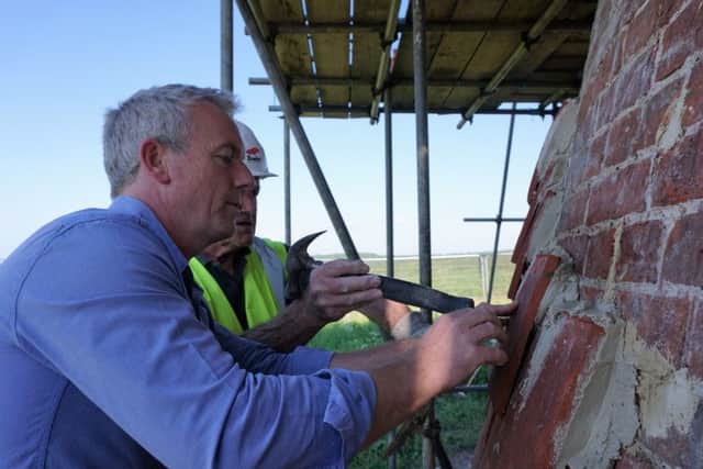 Will Lydon and Frank Sayers of Fowlers fixing tiles during refurbishment