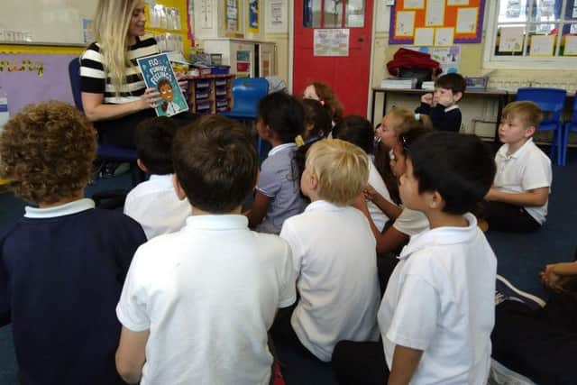 Reading the story to children at Fairlight Primary School