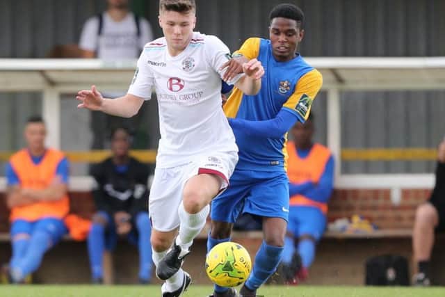 Sam Cruttwell in the thick of the action during Hastings United's FA Trophy win on Sunday. Picture courtesy Scott White