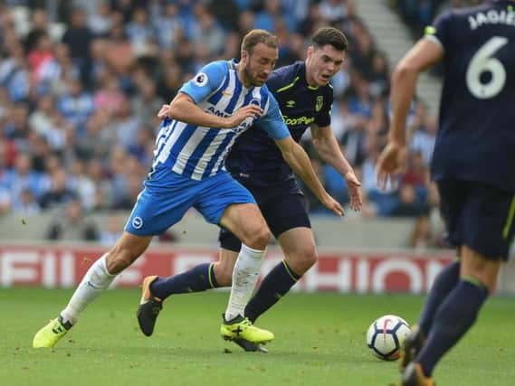 Glenn Murray and Michael Keane battle for possession. Picture by Phil Westlake (PW Sporting Photography)
