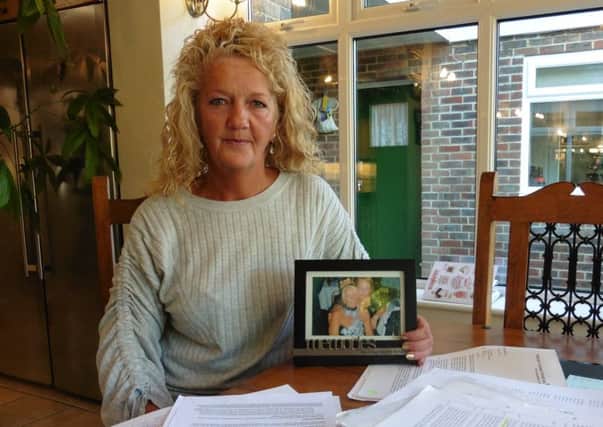 Donna Tomkins with a picture of her mum Lynda Beech, who died four years ago