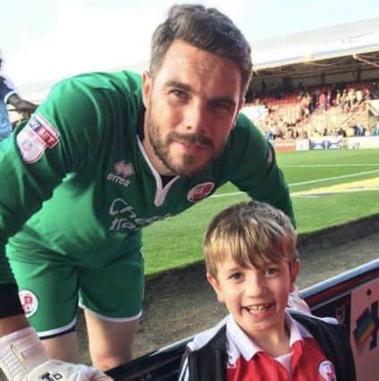 Pictured below after the Grimsby game Crawley Town goalkeeper Glenn Morris with excited young Reds fan Matthew Brown. SUS-171016-130647002