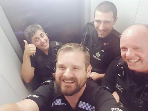 Brighton police officers stuck in a lift (Photograph: Brighton and Hove Police/@BtonHovePOlice)