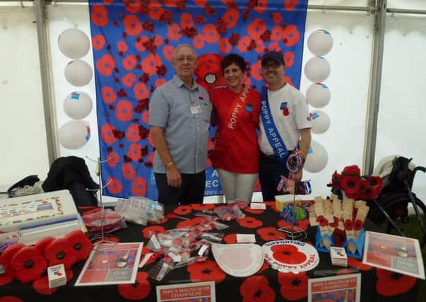 Poppy Appeal organisers Derek Moore MBE, left,  and Charlotte Wright, centre, with volunteer Russ on the right