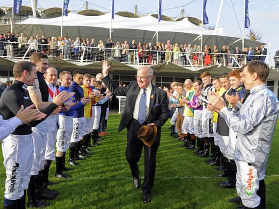 Seamus Buckley gets a guard of honour from the jockeys / Picture by Malcolm Wells
