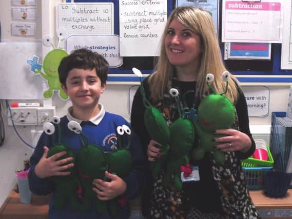 Sam Froggatt and maths subject leader Charlotte Allin with a selection of Pis. Picture by Durrington Infant and Junior School