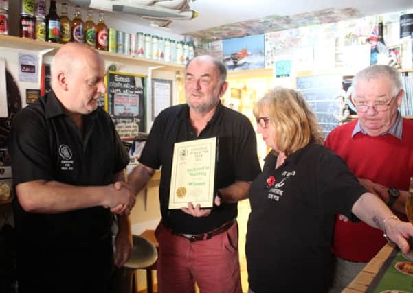 From left to right, Chris Stringer, CAMRA regional director, Nigel Watson and Deborah Blakely, owners of Anchored in Worthing