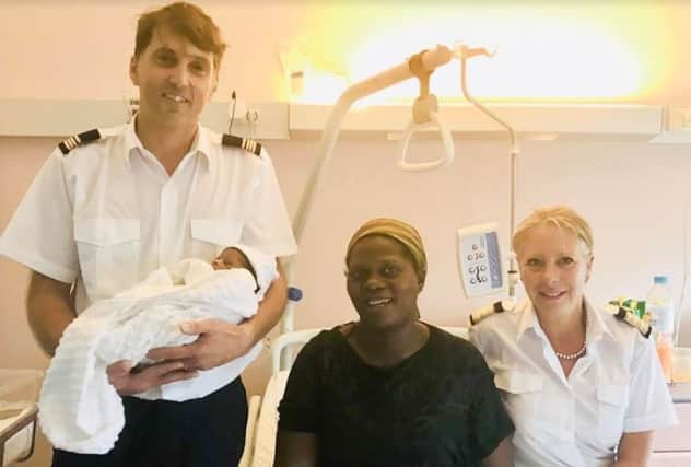 Captian Matthias Bidet holding baby Mustafa, with new mum Sukurat Adeola Abdul Salam and Sabine Licchesi