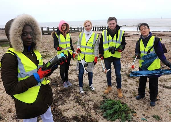 Students carry out a litter pick on East Beach as part of a pilot project being run by the GreenSeas Trust