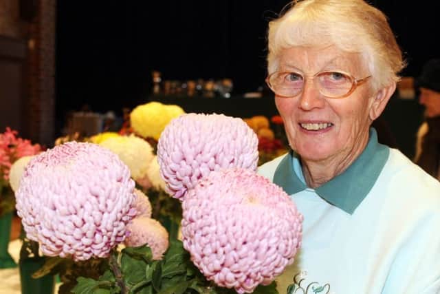 Julie MacCulloch, who won the cup for most points in the members' section, with her prize-winning chrysanthemums. Picture: Derek Martin DM17103365a