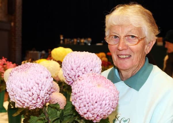 Julie MacCulloch, who won the cup for most points in the members' section, with her prize-winning chrysanthemums. Picture: Derek Martin DM17103365a
