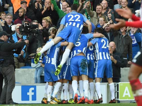 Glenn Murray is mobbed by his Brighton & Hove Albion team-mates after levelling the scores against Southampton. Picture by PW Sporting Pics