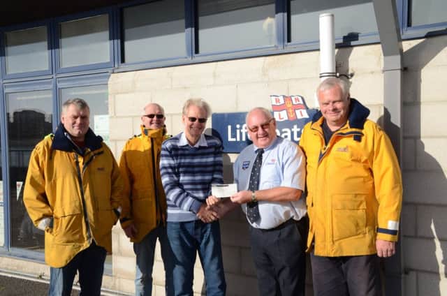 Alan Young of Sovereign Harbour Rotary Club presenting the cheque to Terry Colbran of Eastbourne Lifeboats