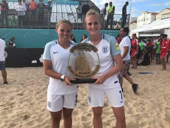 Sarah Kempson (right) celebrates with the Euro Beach Soccer Cup she won while on duty with England earlier in the year