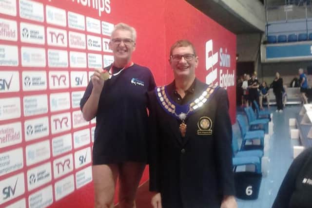 Sally Mills (left) with her gold medal on the podium in Sheffield