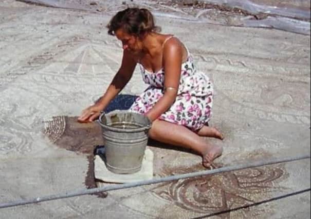 Margaret cleaning a mosaic