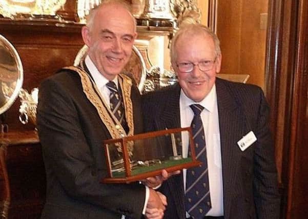 Robert Burgon, master of the Worshipful Company of Plumbers, presenting Phil Mead with the industry heritage award