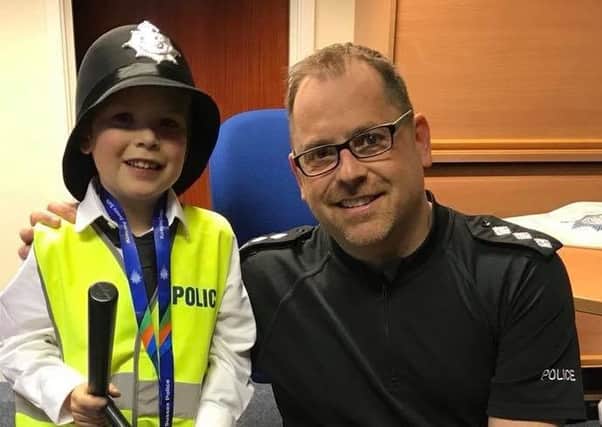 Ch Insp Justin Burtenshaw, pictured with young Danny Herbert from Bognor