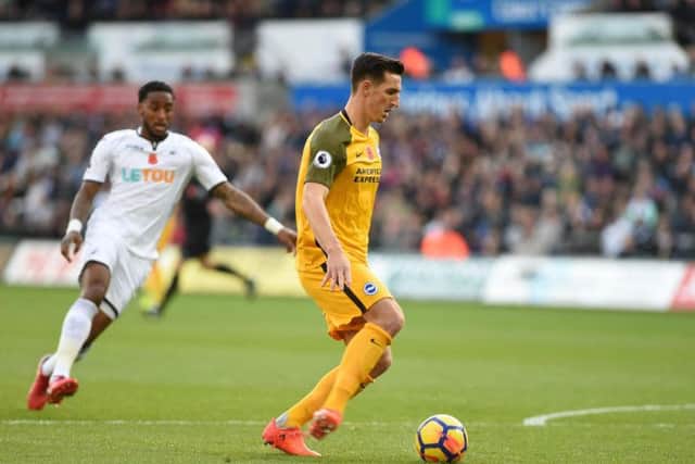 Brighton & Hove Albion defender Lewis Dunk on the ball against Swansea City. Picture by PW Sporting Pics